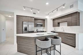 A modern kitchen with a white countertop and brown cabinets.