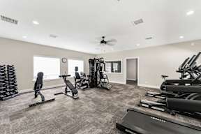 A spacious gym with a variety of exercise equipment.