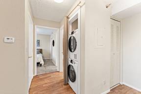 A white washer and dryer in a small room.