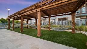 a patio with hammocks and a pergola