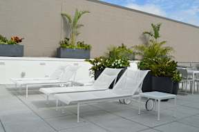 A white lounge chair is on a patio.