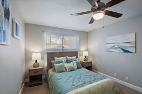 a bedroom with a large bed and a ceiling fan