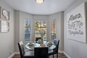 a dining room with a table and chairs and a window
