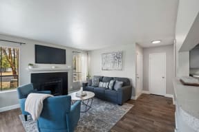 a living room with a fireplace and a tv