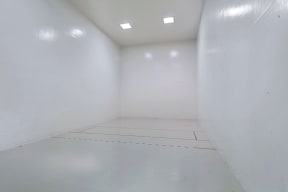 an empty room with white walls and a tile floor