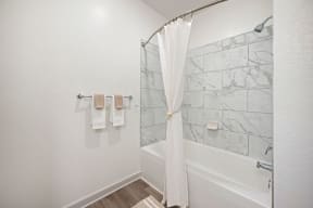 a bathroom with a tub and a shower with a curtain