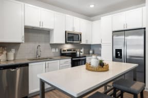a kitchen with stainless steel appliances and a white counter top