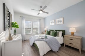 a bedroom with a large bed and a ceiling fan