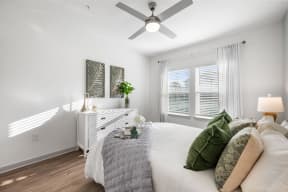 a bedroom with a bed and a ceiling fan