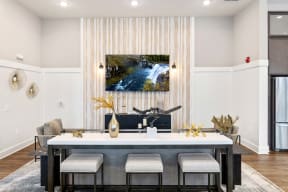 a dining room with a table and chairs and a painting on the wall