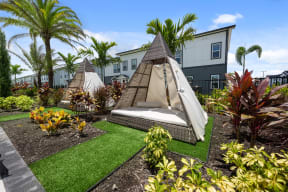 a bed in a garden with palm trees