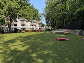 A park with a red object on the grass.