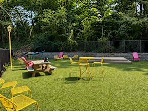 A backyard with a picnic table and chairs.