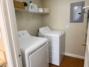 A small laundry room with a washer and dryer.