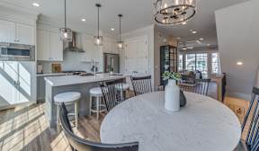 A modern kitchen with a large island and bar stools.