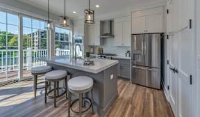 A kitchen with a bar area and stools.