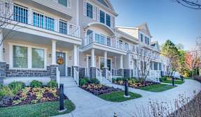 A row of houses with a walkway in between.