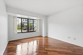 A room with wooden floors and a large window.