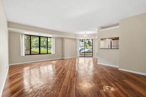 A room with wooden floors and a sliding glass door.