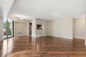 A room with wooden floors and white walls.