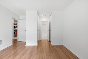 A long hallway with a door on the left and a door on the right.