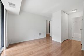 A room with white walls and wooden flooring.