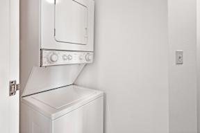 A stacked in-unit washer and dryer.