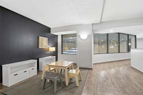 A modern dining room with a wooden table and chairs.