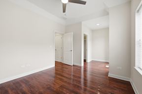 A room with wooden floors and white walls.