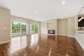 A spacious room with a fireplace and sliding glass doors.