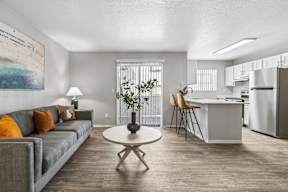 A living room with a grey couch and a white coffee table.