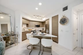 a kitchen and dining area with a table and chairs