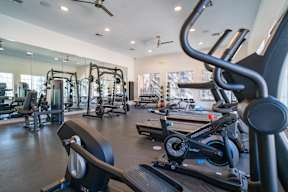 a gym with cardio machines and other exercise equipment