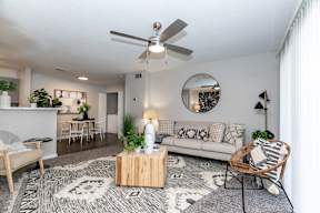 a living room with a couch and a ceiling fan