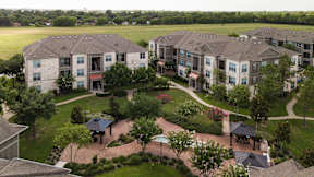 A large apartment complex with a courtyard and landscaping.
