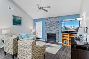 a living room with a couch and a chair and a fireplace
