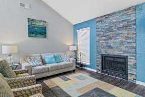 a living room with a couch and chairs and a fireplace