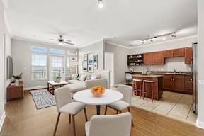 A modern kitchen with a dining table set for four.