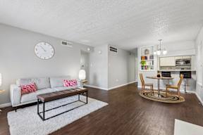 A living room with a grey couch and a wooden coffee table.