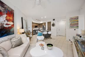 a living room with a white couch and a white coffee table