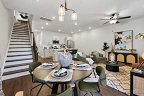 A modern dining room with a round table set for two.