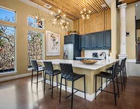 a kitchen with a large center island with a marble countertop