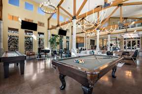a large clubhouse with a pool table and a ping pong table