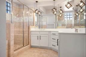 a bathroom with a large shower and two sinks