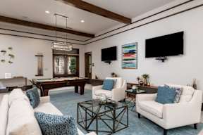 game room with white sofas