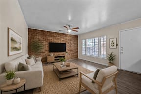 A living room with a couch, chair, and a television.