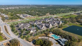 an aerial view of a neighborhood with houses and a swimming pool