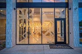 The front of a building with a glass door and a sign that says "The Charwell Arthron Village".