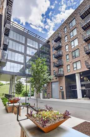 A modern building with a large planter in the foreground.
