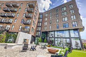A modern building with a courtyard in front.